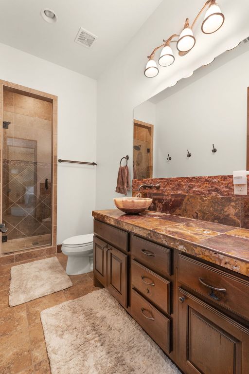 2904 Kodiak Cv, Cedar Park, TX 78613 - bathroom featuring double vanity, a stall shower, and toilet