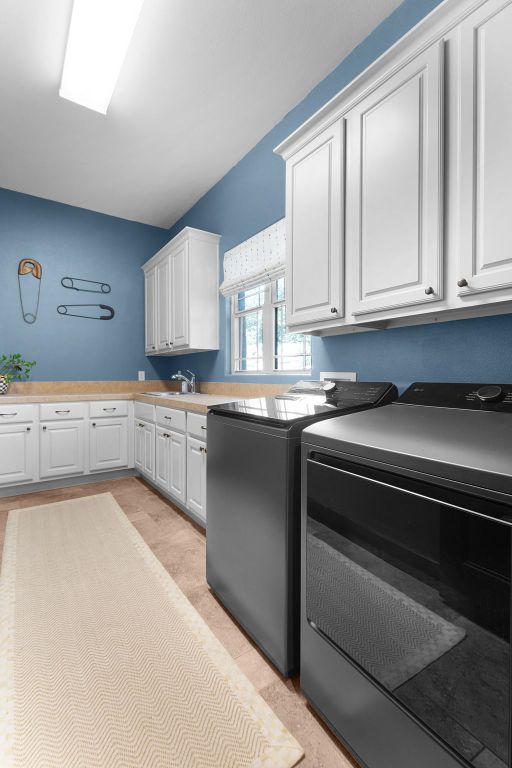 2904 Kodiak Cv, Cedar Park, TX 78613 - laundry room with cabinet space and washer and clothes dryer