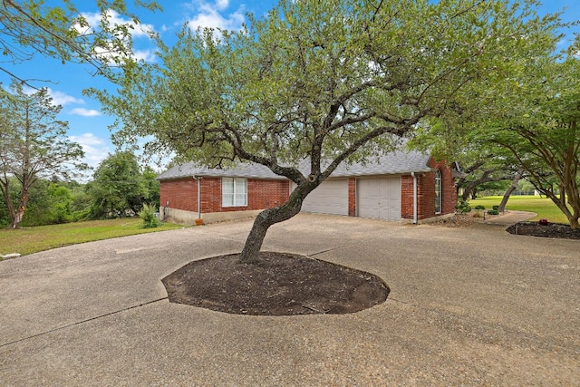 10003 Baxter Ln, Austin, TX 78736 - view of front of property featuring brick siding, concrete driveway, and a garage