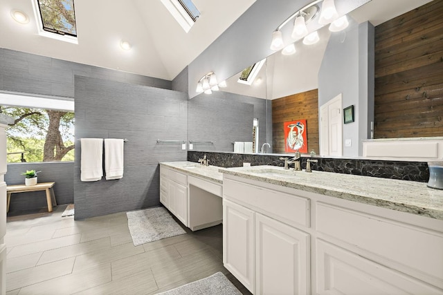 10003 Baxter Ln, Austin, TX 78736 - bathroom featuring high vaulted ceiling, double vanity, and a skylight
