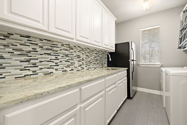 10003 Baxter Ln, Austin, TX 78736 - washroom with washing machine and dryer and baseboards
