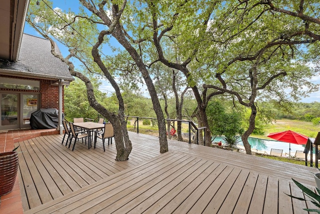 10003 Baxter Ln, Austin, TX 78736 - wooden deck featuring area for grilling, outdoor dining space, and an outdoor pool
