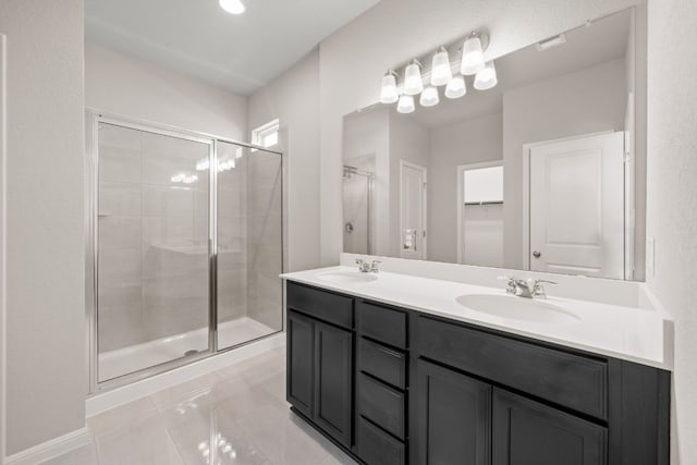 122 Elm Branch Trl, Taylor, TX 76574 - bathroom featuring a shower stall, double vanity, and a spacious closet