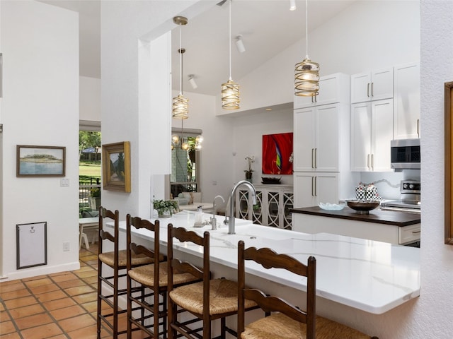 106 Southern Spur, Horseshoe Bay, TX 78657 - dining room featuring high vaulted ceiling and light tile patterned floors