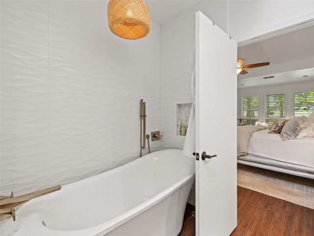106 Southern Spur, Horseshoe Bay, TX 78657 - ensuite bathroom featuring a freestanding bath, wood finished floors, and ceiling fan