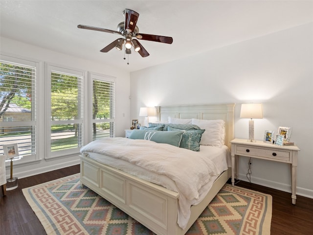 106 Southern Spur, Horseshoe Bay, TX 78657 - bedroom featuring dark wood-type flooring, a ceiling fan, and baseboards