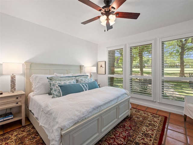 106 Southern Spur, Horseshoe Bay, TX 78657 - bedroom featuring multiple windows, tile patterned flooring, and ceiling fan