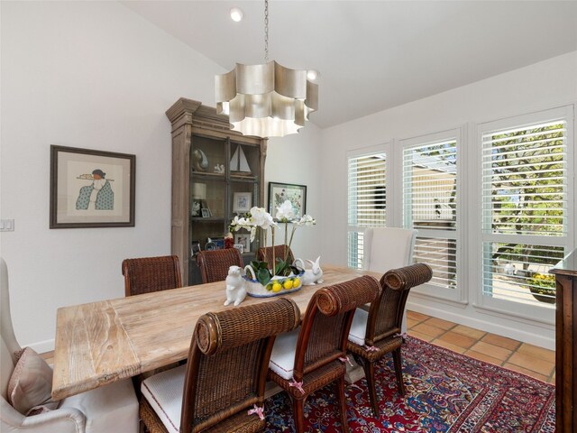 106 Southern Spur, Horseshoe Bay, TX 78657 - dining space featuring a chandelier, vaulted ceiling, and tile patterned floors