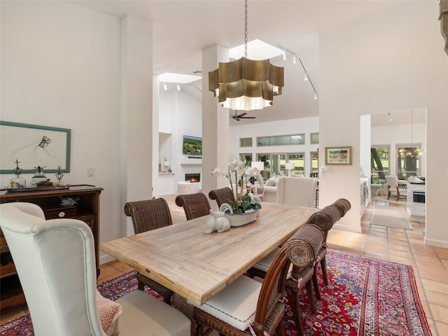 106 Southern Spur, Horseshoe Bay, TX 78657 - dining space featuring a high ceiling, rail lighting, light tile patterned flooring, and a ceiling fan