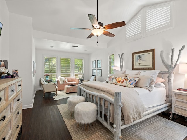106 Southern Spur, Horseshoe Bay, TX 78657 - bedroom with dark wood-style floors, baseboards, lofted ceiling, and a ceiling fan