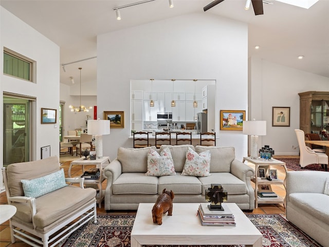 106 Southern Spur, Horseshoe Bay, TX 78657 - living room featuring high vaulted ceiling, ceiling fan, a chandelier, and track lighting