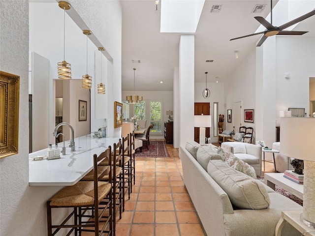 106 Southern Spur, Horseshoe Bay, TX 78657 - living area with a high ceiling, ceiling fan, and light tile patterned floors