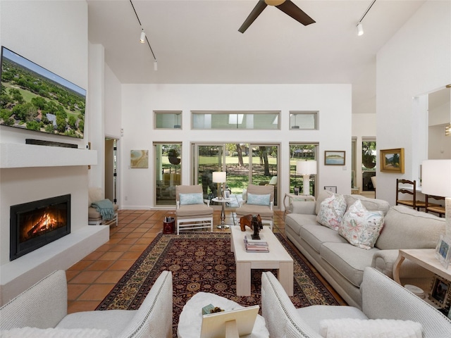 106 Southern Spur, Horseshoe Bay, TX 78657 - living area featuring rail lighting, a towering ceiling, plenty of natural light, a ceiling fan, and tile patterned floors