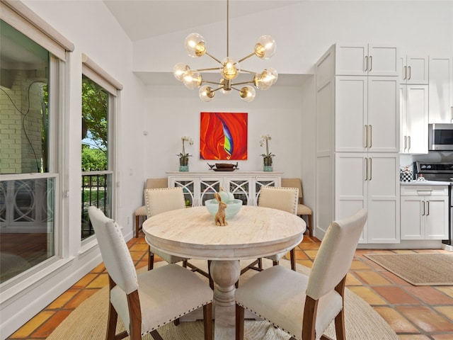 106 Southern Spur, Horseshoe Bay, TX 78657 - dining room with a chandelier, lofted ceiling, and light tile patterned floors