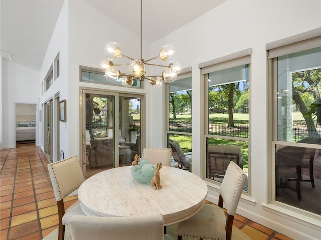106 Southern Spur, Horseshoe Bay, TX 78657 - tiled dining space featuring a chandelier and high vaulted ceiling