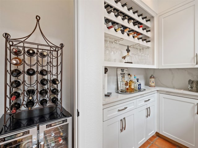 106 Southern Spur, Horseshoe Bay, TX 78657 - wine cellar featuring a bar, beverage cooler, and light tile patterned flooring