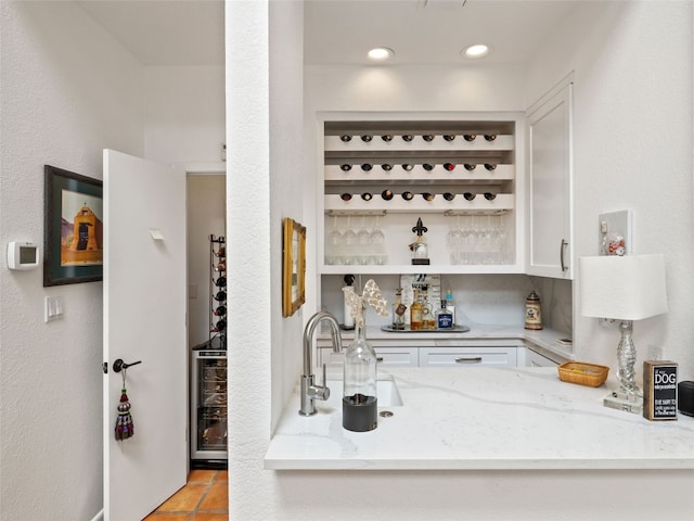 106 Southern Spur, Horseshoe Bay, TX 78657 - wine room featuring bar with sink, wine cooler, and light tile patterned floors
