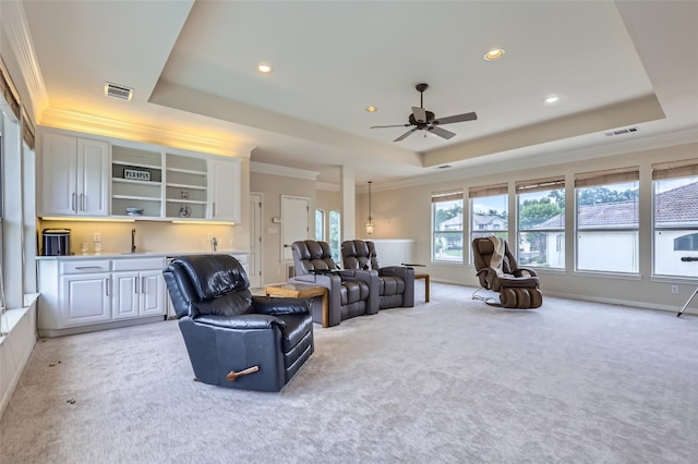 29 Tiburon Dr, The Hills, TX 78738 - living area featuring a tray ceiling, light colored carpet, a ceiling fan, crown molding, and recessed lighting