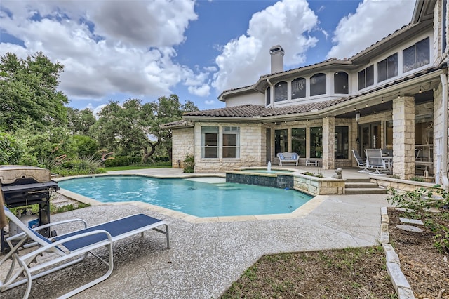 29 Tiburon Dr, The Hills, TX 78738 - view of swimming pool featuring a patio area, a pool with connected hot tub, and area for grilling