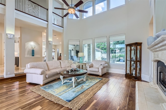 29 Tiburon Dr, The Hills, TX 78738 - living area with a high ceiling, a ceiling fan, a fireplace, and wood-type flooring