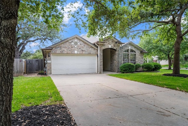 10500 Hendon St, Austin, TX 78748 - view of front of house featuring an attached garage, concrete driveway, and stone siding