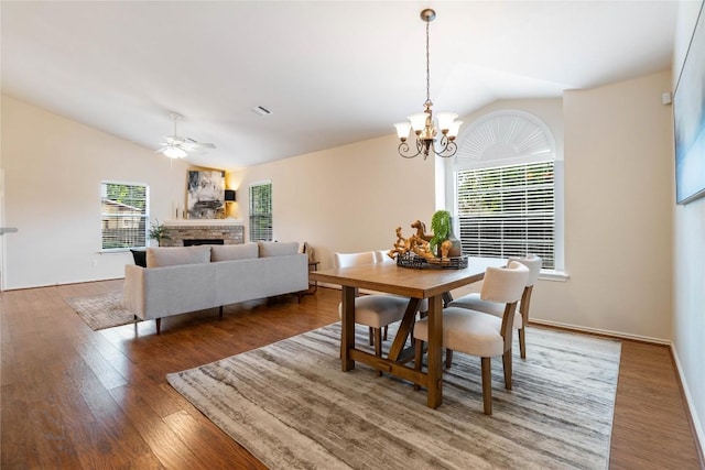 10500 Hendon St, Austin, TX 78748 - dining area with vaulted ceiling, healthy amount of natural light, a brick fireplace, wood finished floors, and a chandelier