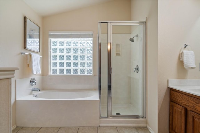 10500 Hendon St, Austin, TX 78748 - bathroom with vanity, a bath, a shower stall, tile patterned flooring, and lofted ceiling