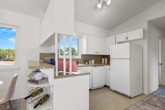 8900 Tina Ct, Austin, TX 78758 - kitchen featuring white appliances, a textured ceiling, vaulted ceiling, white cabinets, and a sink