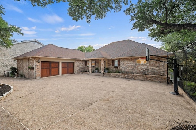 3404 Riva Ridge Rd, Austin, TX 78746 - view of front of property with a garage, driveway, brick siding, and a shingled roof