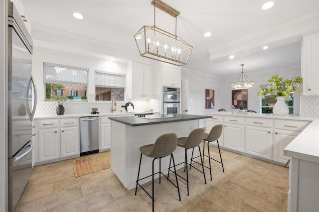 3404 Riva Ridge Rd, Austin, TX 78746 - kitchen featuring stainless steel appliances, a chandelier, decorative backsplash, recessed lighting, and ornamental molding