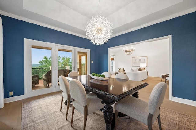 3404 Riva Ridge Rd, Austin, TX 78746 - dining area featuring a chandelier, wood finished floors, crown molding, baseboards, and french doors