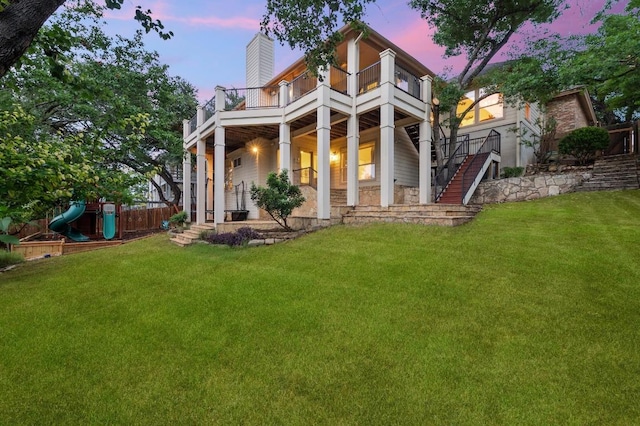 3404 Riva Ridge Rd, Austin, TX 78746 - back of house featuring a balcony, stairway, a chimney, and a playground