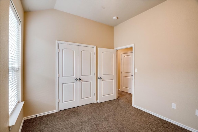 113-119 Creekside Villa Dr, Kyle, TX 78640 - unfurnished bedroom featuring carpet floors, lofted ceiling, a closet, and baseboards