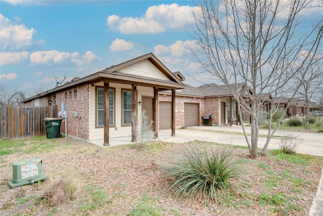 113-119 Creekside Villa Dr, Kyle, TX 78640 - single story home featuring driveway, brick siding, an attached garage, and a porch