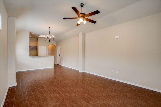 113-119 Creekside Villa Dr, Kyle, TX 78640 - unfurnished living room featuring vaulted ceiling, ceiling fan, arched walkways, dark wood-type flooring, and baseboards