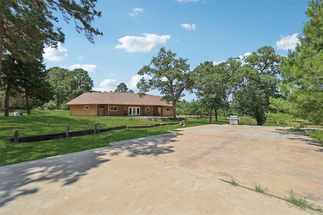 129 Country Air Dr, Bastrop, TX 78602 - view of front facade with concrete driveway and a front lawn