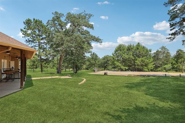 129 Country Air Dr, Bastrop, TX 78602 - view of green lawn featuring a ceiling fan and a patio area