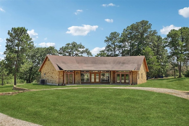 129 Country Air Dr, Bastrop, TX 78602 - view of front of home with french doors, a front yard, and brick siding