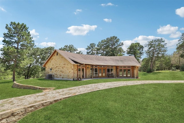 129 Country Air Dr, Bastrop, TX 78602 - ranch-style house with french doors, a front lawn, and stone siding