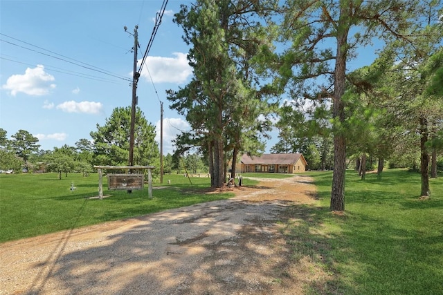 129 Country Air Dr, Bastrop, TX 78602 - view of front of property with a front lawn and driveway