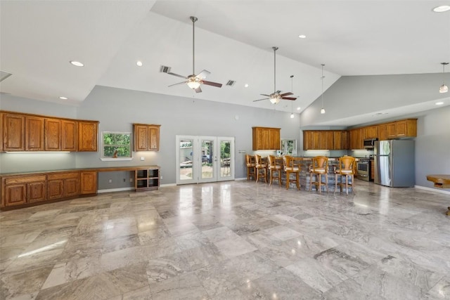 129 Country Air Dr, Bastrop, TX 78602 - kitchen featuring appliances with stainless steel finishes, brown cabinetry, high vaulted ceiling, ceiling fan, and recessed lighting