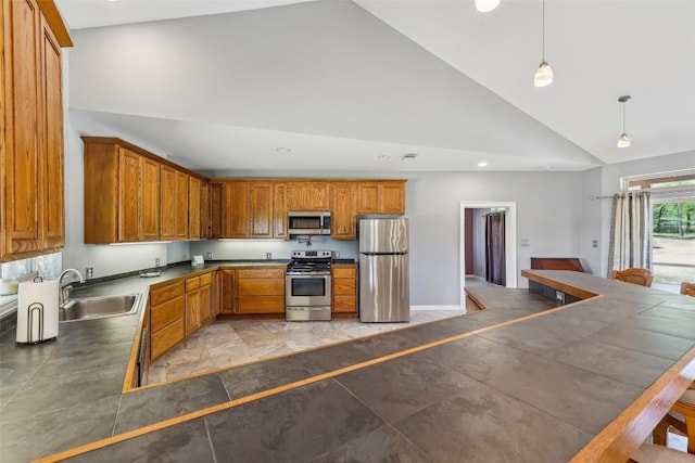 129 Country Air Dr, Bastrop, TX 78602 - kitchen featuring appliances with stainless steel finishes, high vaulted ceiling, brown cabinets, dark countertops, and recessed lighting