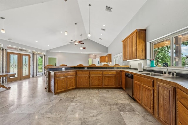 129 Country Air Dr, Bastrop, TX 78602 - kitchen with brown cabinetry, stainless steel dishwasher, french doors, a peninsula, and healthy amount of natural light