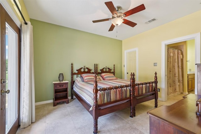 129 Country Air Dr, Bastrop, TX 78602 - bedroom featuring connected bathroom, ceiling fan, and light tile patterned floors