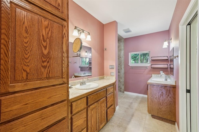 129 Country Air Dr, Bastrop, TX 78602 - full bath featuring two vanities and baseboards