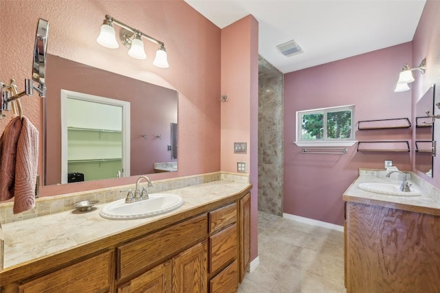 129 Country Air Dr, Bastrop, TX 78602 - bathroom featuring vanity and a walk in closet