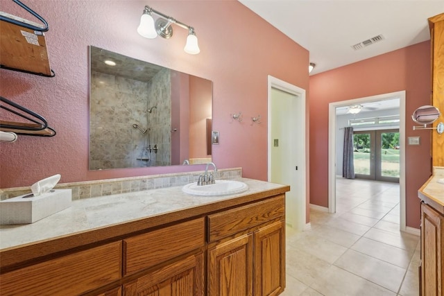 129 Country Air Dr, Bastrop, TX 78602 - full bath with tiled shower, vanity, french doors, and tile patterned floors