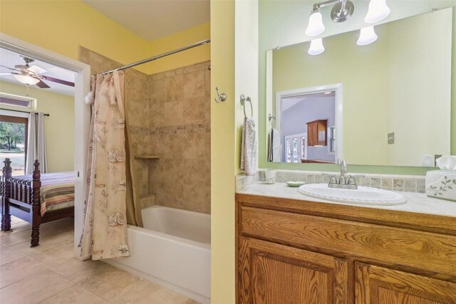 129 Country Air Dr, Bastrop, TX 78602 - ensuite bathroom featuring tile patterned floors, shower / bath combination with curtain, vanity, and ceiling fan