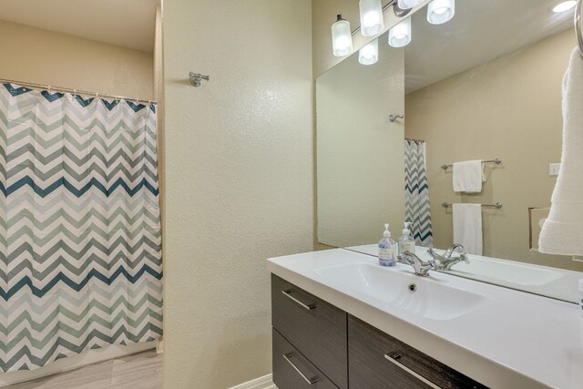 8132 Amelia Cv, Austin, TX 78750 - bathroom with vanity, curtained shower, and a textured wall