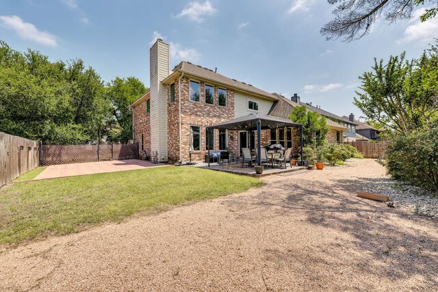 8132 Amelia Cv, Austin, TX 78750 - rear view of house with brick siding, a chimney, a patio, and a fenced backyard